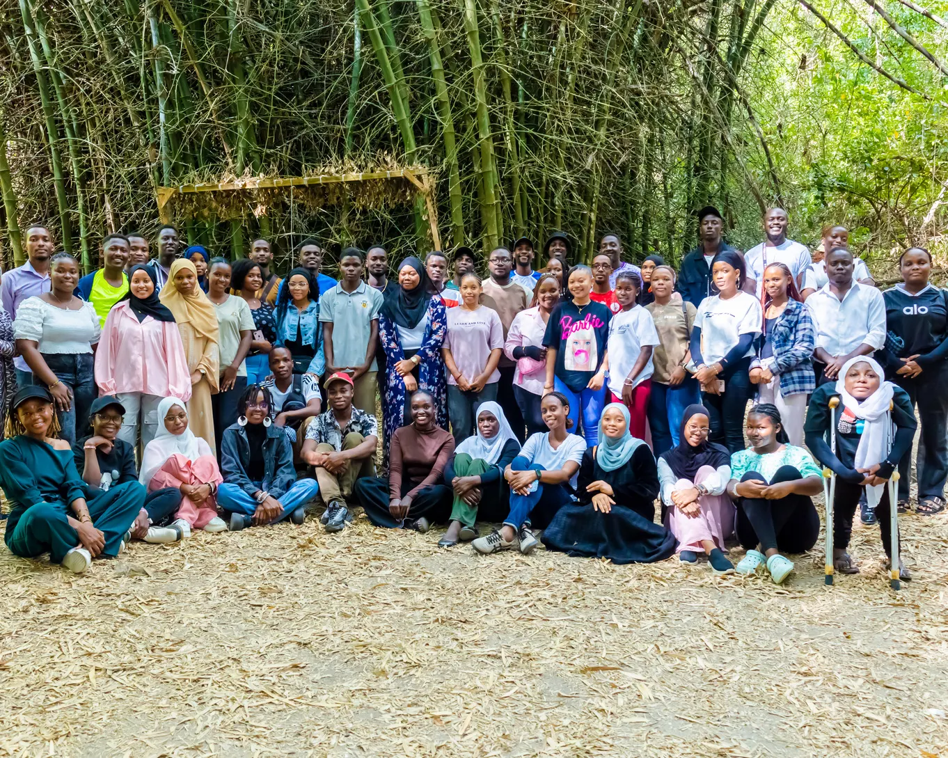 Large youth cohort gathered in a bamboo grove